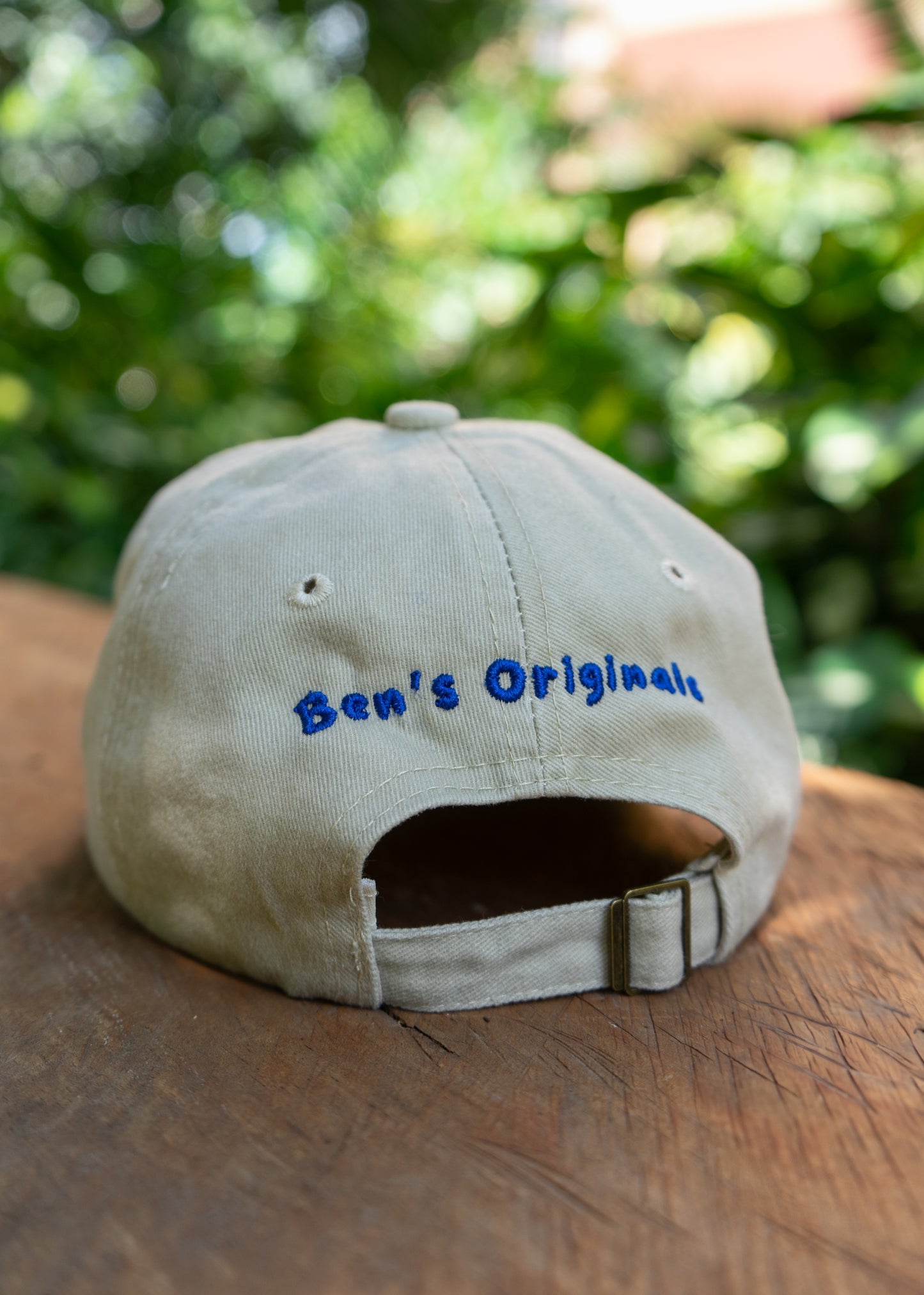 Rear view of Ben’s Originals sailfish cap in washed beige cotton with embroidered logo, adjustable fabric strap and brass buckle.