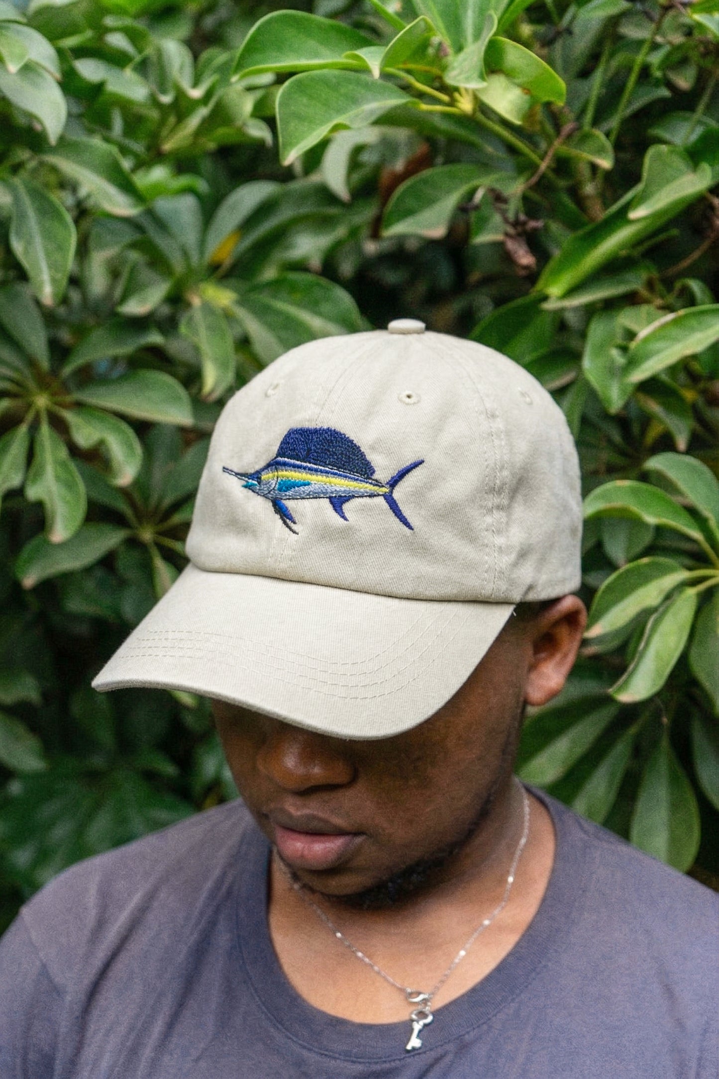 Front view of Ben’s Originals Kenya sailfish cap in washed beige cotton with detailed embroidered sailfish design and curved brim.